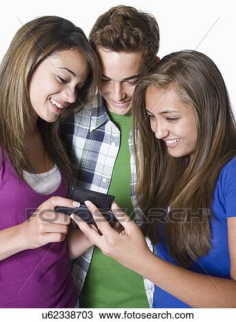 Three teenage friends with pda, smiling View Large Photo Image Stock Image - Three teenage friends with pda, smiling. Fotosearch