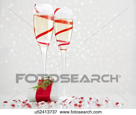 Stock Photo - Two champagne flutes and gift. Fotosearch