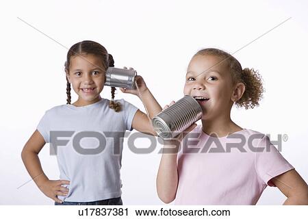 Two girls (6-7, 8-9) playing with tin can phone View Large Photo Image Stock Image - Two girls (6-7, 8-9) playing with tin can phone. Fotosearch