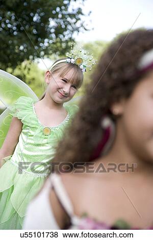 Stock Photo - Two girls (8-9) in Halloween costumes. Fotosearch