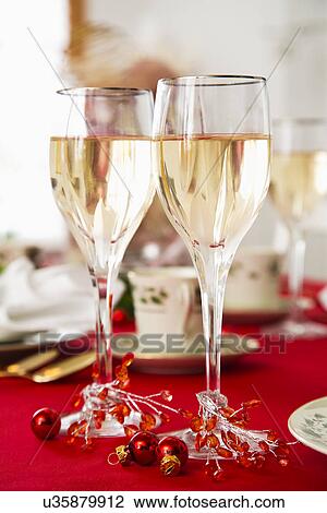 Stock Image - Two glasses of wine on Christmas table . Fotosearch