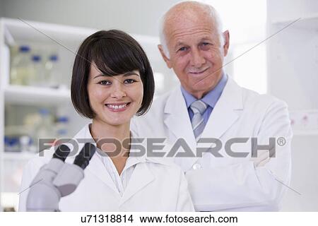 Picture - Two scientist in laboratory, portrait. Fotosearch