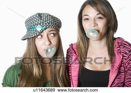 Two teenage girls blowing bubbles, portrait View Large Photo Image Stock Photo - Two teenage girls blowing bubbles, portrait. Fotosearch