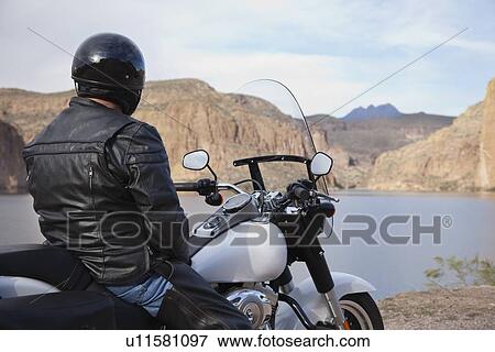 Stock Photo - USA, Arizona, Phoenix, Biker on motorcycle in mountain area. Fotosearch