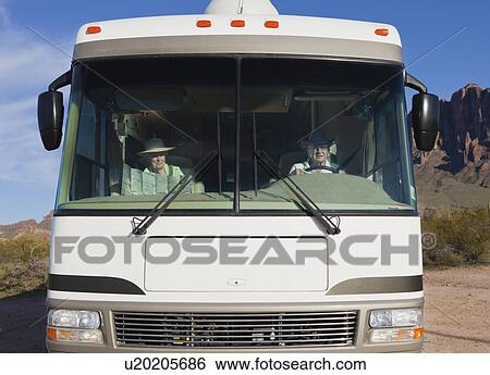 Stock Photograph - USA, Arizona, Senior couple in motor home. Fotosearch