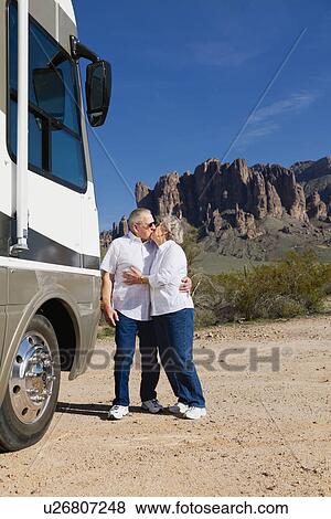 USA, Arizona, Senior couple standing next to motor home and kissing View Large Photo Image Stock Photo - USA, Arizona, Senior couple standing next to motor home and kissing. Fotosearch