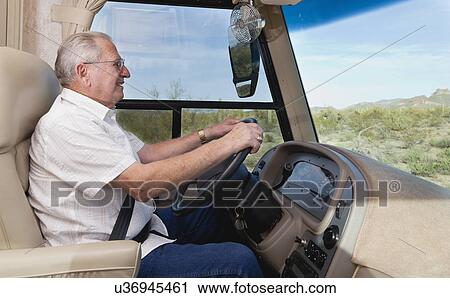 Stock Image - USA, Arizona, senior man driving car. Fotosearch