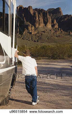 Picture - USA, Arizona, Senior man leaning at motor home. Fotosearch