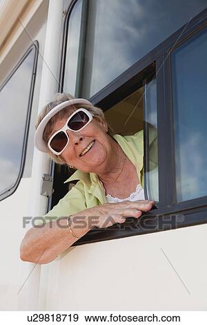USA, Arizona, Senior woman wearing sunglasses looking through window of motor home View Large Photo Image Stock Photo - USA, Arizona, Senior woman wearing sunglasses looking through window of motor home. Fotosearch