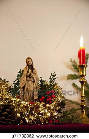 Stock Image - USA California, Fairfax, christmas still life with Virgin Mary figurine and candles. Fotosearch