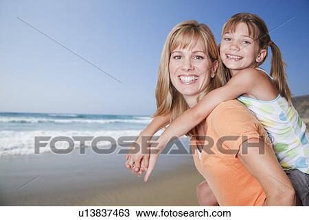 USA, California, Fairfax, Daughter (8-9) embracing mother on beach View Large Photo Image Stock Image - USA, California, Fairfax, Daughter (8-9) embracing mother on beach. Fotosearch