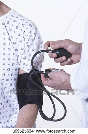 USA, California, Fairfax, Doctor checking female patient's blood pressure View Large Photo Image Picture - USA, California, Fairfax, Doctor checking female patient's blood pressure. Fotosearch