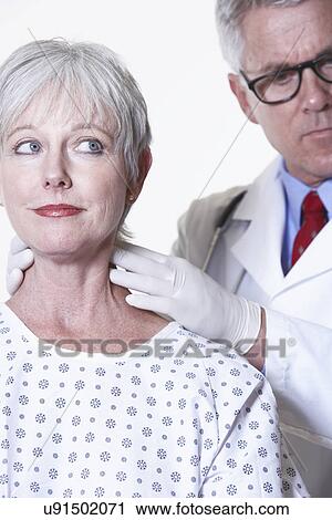 Stock Image - USA, California, Fairfax, Doctor examining female patient. Fotosearch