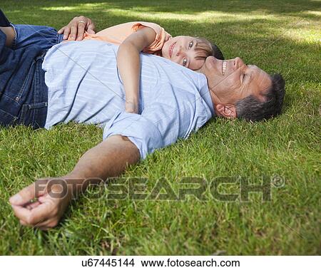 USA, California, Fairfax, Father and daughter (8-9) lying on grass View Large Photo Image Picture - USA, California, Fairfax, Father and daughter (8-9) lying on grass. Fotosearch
