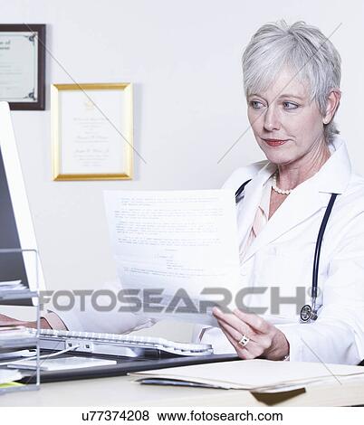 USA, California, Fairfax, Female doctor using computer at desk View Large Photo Image Stock Photo - USA, California, Fairfax, Female doctor using computer at desk. Fotosearch