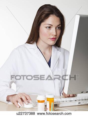 Stock Photo - USA, California, Fairfax, Female scientist using computer. Fotosearch