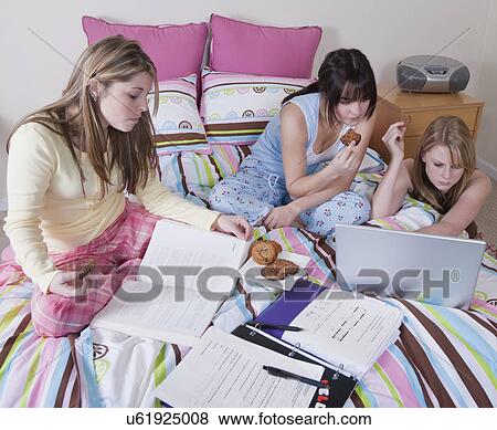 USA, California, Fairfax, girls (15-18) doing homework on bed View Large Photo Image Stock Photo - USA, California, Fairfax, girls (15-18) doing homework on bed. Fotosearch