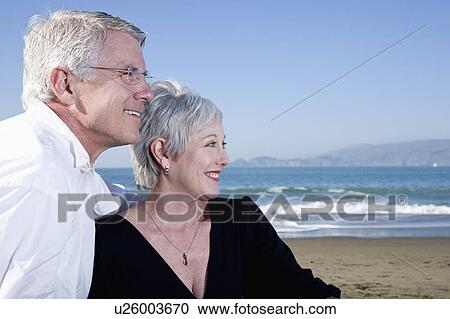USA, California, Fairfax, Happy mature couple sitting on beach View Large Photo Image Stock Image - USA, California, Fairfax, Happy mature couple sitting on beach. Fotosearch