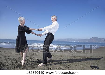 USA, California, Fairfax, Happy mature couple dancing on beach View Large Photo Image Stock Image - USA, California, Fairfax, Happy mature couple dancing on beach. Fotosearch