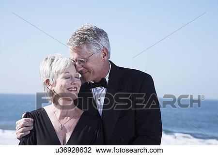 USA, California, Fairfax, Happy mature couple hugging on beach View Large Photo Image Stock Image - USA, California, Fairfax, Happy mature couple hugging on beach. Fotosearch