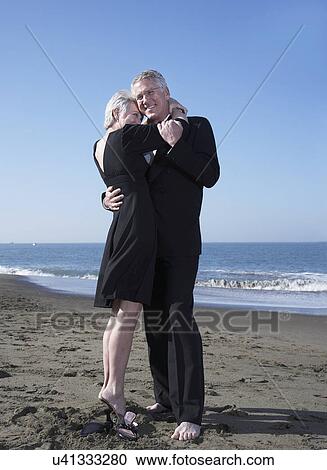 USA, California, Fairfax, Happy mature couple hugging on beach View Large Photo Image Stock Image - USA, California, Fairfax, Happy mature couple hugging on beach. Fotosearch