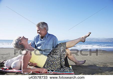 USA, California, Fairfax, Happy mature couple relaxing on beach View Large Photo Image Stock Image - USA, California, Fairfax, Happy mature couple relaxing on beach. Fotosearch