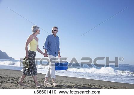 USA, California, Fairfax, Happy mature couple walking on beach View Large Photo Image Stock Image - USA, California, Fairfax, Happy mature couple walking on beach. Fotosearch