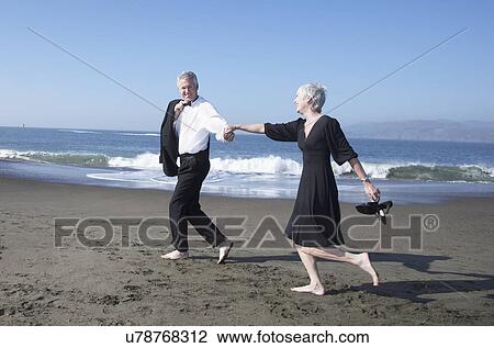 USA, California, Fairfax, Happy mature couple walking on beach View Large Photo Image Stock Image - USA, California, Fairfax, Happy mature couple walking on beach. Fotosearch