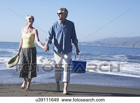 USA, California, Fairfax, Happy mature couple walking on beach View Large Photo Image Stock Photo - USA, California, Fairfax, Happy mature couple walking on beach. Fotosearch