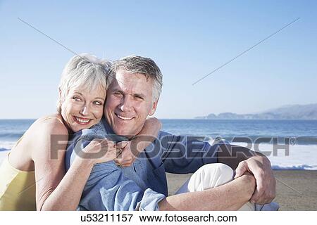 USA, California, Fairfax, Happy mature couple sitting on beach View Large Photo Image Stock Photo - USA, California, Fairfax, Happy mature couple sitting on beach. Fotosearch