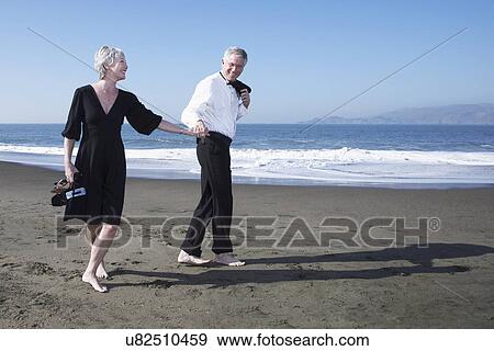 USA, California, Fairfax, Happy mature couple walking on beach View Large Photo Image Stock Photo - USA, California, Fairfax, Happy mature couple walking on beach. Fotosearch