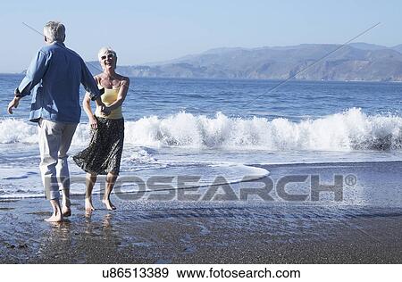 USA, California, Fairfax, Happy mature couple dancing on beach View Large Photo Image Stock Photo - USA, California, Fairfax, Happy mature couple dancing on beach. Fotosearch