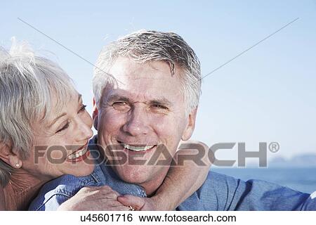 USA, California, Fairfax, Happy mature couple sitting on beach View Large Photo Image Stock Photograph - USA, California, Fairfax, Happy mature couple sitting on beach. Fotosearch