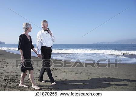 USA, California, Fairfax, Happy mature couple walking on beach View Large Photo Image Stock Photography - USA, California, Fairfax, Happy mature couple walking on beach. Fotosearch
