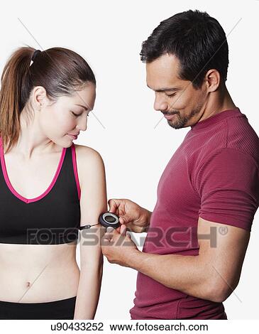 Stock Image - USA, California, Fairfax, Man measuring woman's pulse. Fotosearch