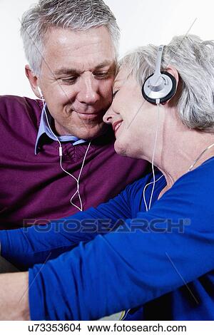 Picture - USA, California, Fairfax, Mature couple listening music together. Fotosearch