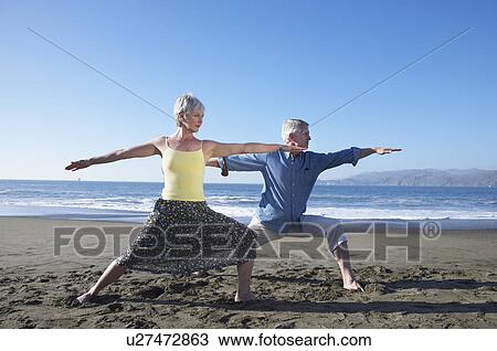 USA, California, Fairfax, Mature couple in warrior yoga pose on beach View Large Photo Image Stock Image - USA, California, Fairfax, Mature couple in warrior yoga pose on beach. Fotosearch