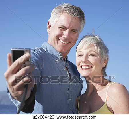USA, California, Fairfax, Mature couple photographing self against blue sky View Large Photo Image Stock Photograph - USA, California, Fairfax, Mature couple photographing self against blue sky. Fotosearch