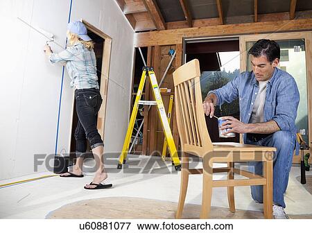 Stock Photo - USA, California, Fairfax, Mid adult couple doing home improvement work together. Fotosearch