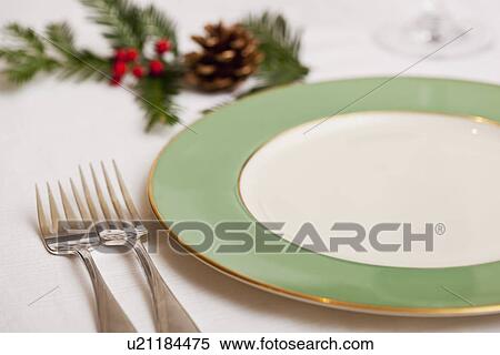 Stock Photography - USA California, Fairfax, plate and Christmas decoration on table. Fotosearch