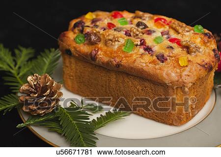 Stock Image - USA California, Fairfax, plate with fruitcake and Christmas decoration. Fotosearch