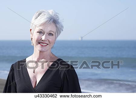 USA, California, Fairfax, Portrait of smiling woman on beach View Large Photo Image Stock Image - USA, California, Fairfax, Portrait of smiling woman on beach. Fotosearch