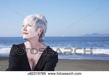 Stock Photo - USA, California, Fairfax, Portrait of pensive woman on beach. Fotosearch