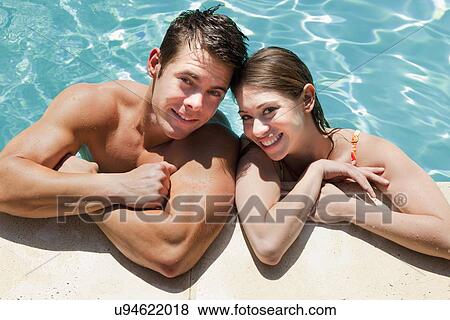 USA, California, Fairfax, Portrait of young couple in swimming pool View Large Photo Image Stock Photo - USA, California, Fairfax, Portrait of young couple in swimming pool. Fotosearch