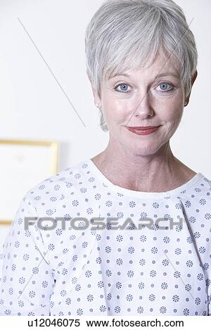 USA, California, Fairfax, Portrait of woman in hospital gown sitting in doctor's office View Large Photo Image Stock Photography - USA, California, Fairfax, Portrait of woman in hospital gown sitting in doctor's office. Fotosearch
