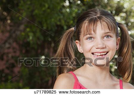 Stock Photography - USA, California, Fairfax, Portrait of girl (8-9) smiling. Fotosearch