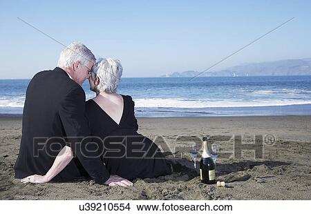 USA, California, Fairfax, Rear view of mature elegant couple sitting on beach with wine View Large Photo Image Picture - USA, California, Fairfax, Rear view of mature elegant couple sitting on beach with wine. Fotosearch