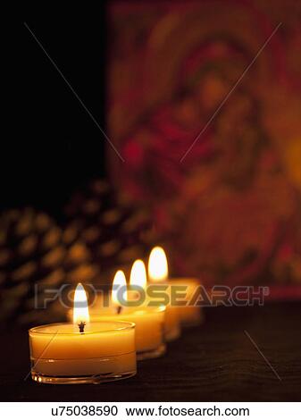 Stock Image - USA California, Fairfax, row of candles, defocused icon with Virgin Mary and Jesus in background. Fotosearch
