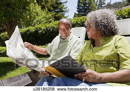 USA, California, Fairfax, Senior couple reading in garden View Large Photo Image Stock Photo - USA, California, Fairfax, Senior couple reading in garden. Fotosearch