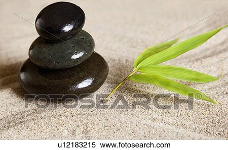 Stock Photography - USA, California, Fairfax, Stacked stones with leaf in rock garden. Fotosearch